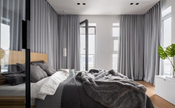 Luxury bedroom interior with double bed and gray window curtains